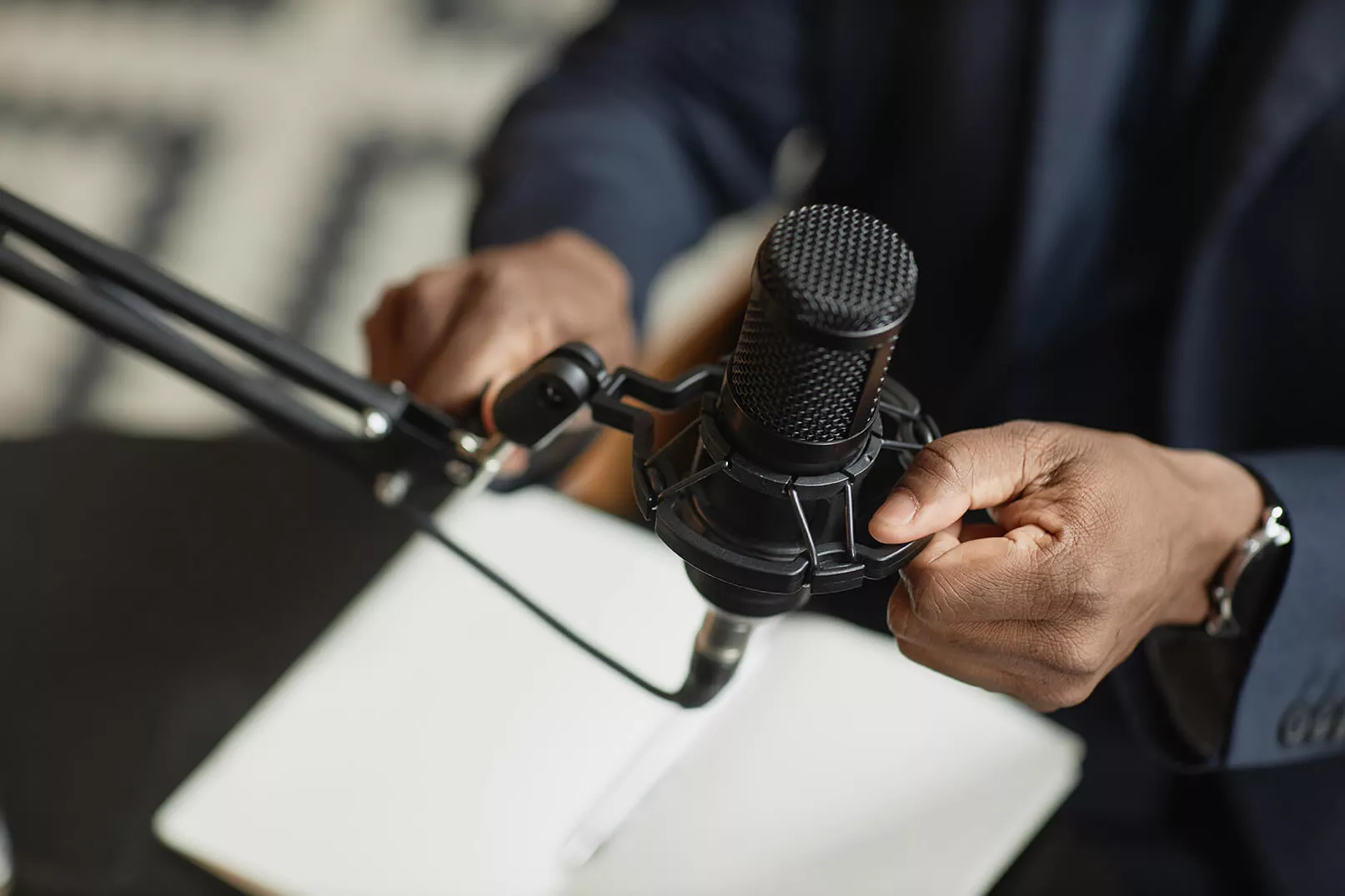 male hand holding studio microphone > 911myweb.com